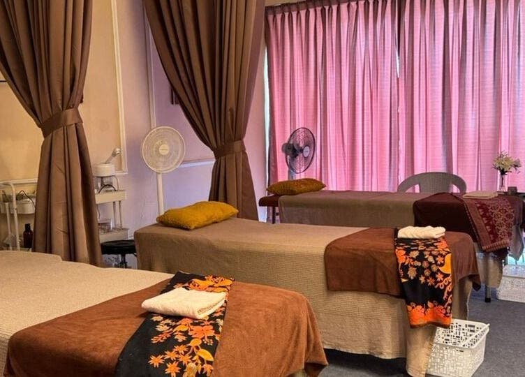 Calming massage room at Bidan Cantik Spa in Sungai Petani, Kedah, MY, featuring soft lighting and comfortable tables.