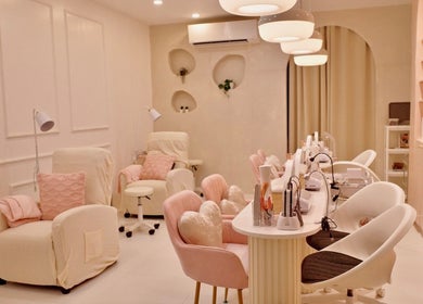 Modern interior of Blooming Nails Beauty Studio in Bacoor, Calabarzon, PH, featuring plush chairs and sleek decor.