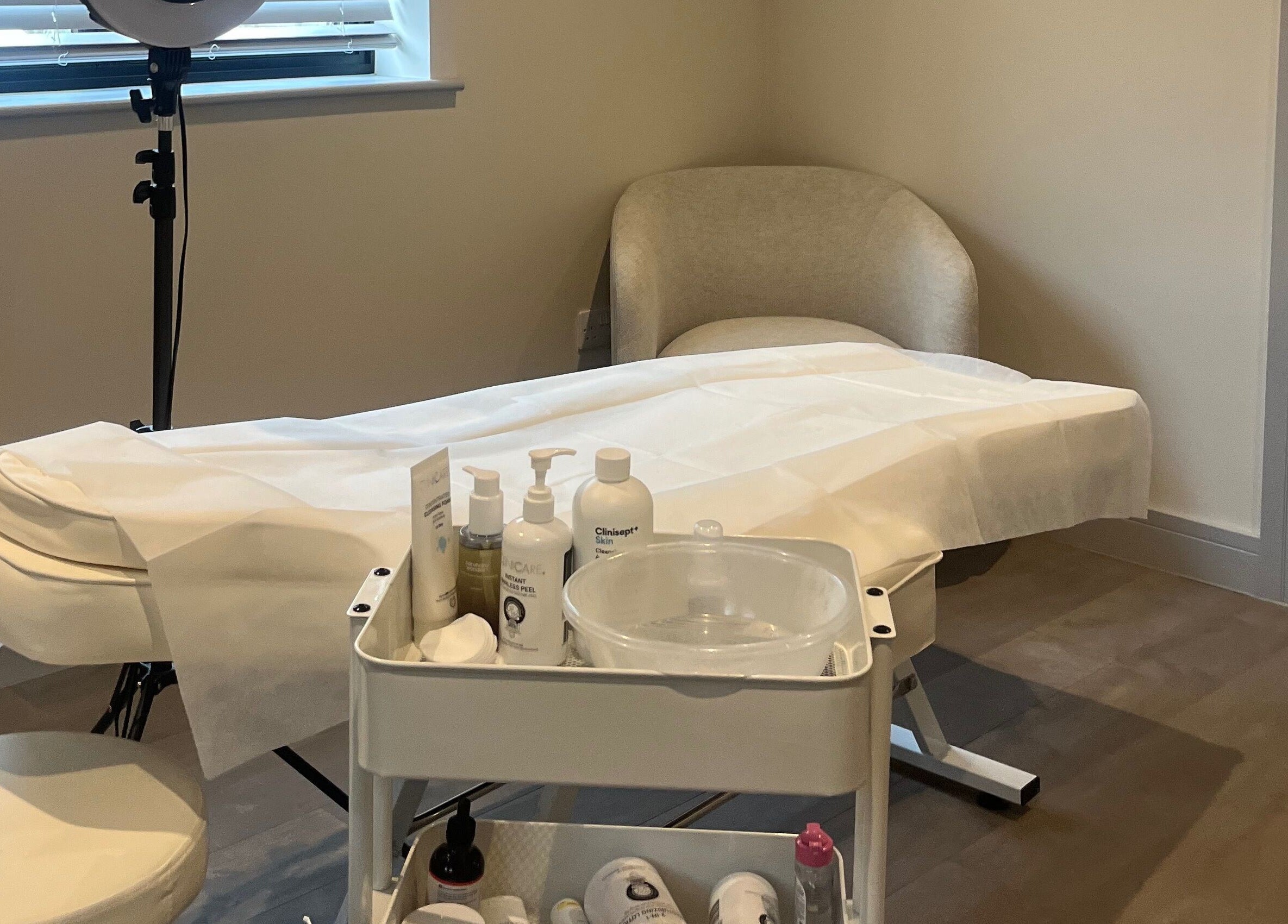 Calming treatment room at Skin Space, Stevenage, England, GB with a massage table and skincare products.