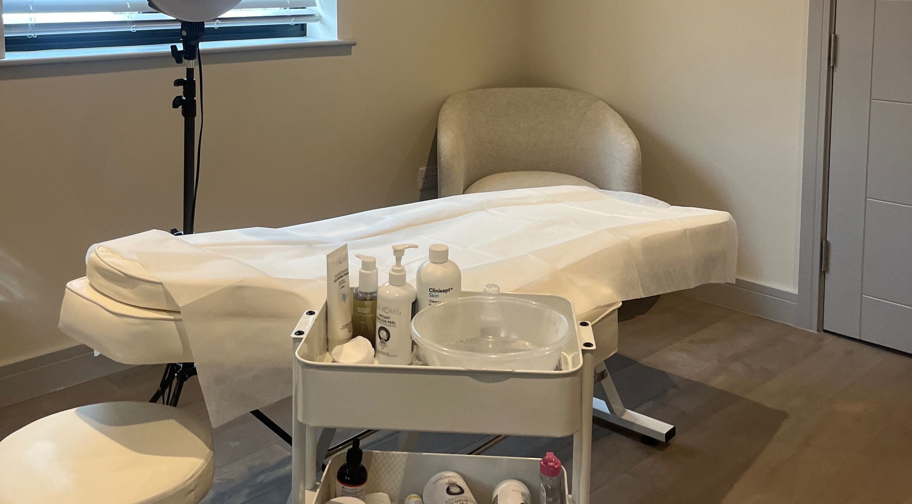 Calming treatment room at Skin Space, Stevenage, England, GB with a massage table and skincare products.