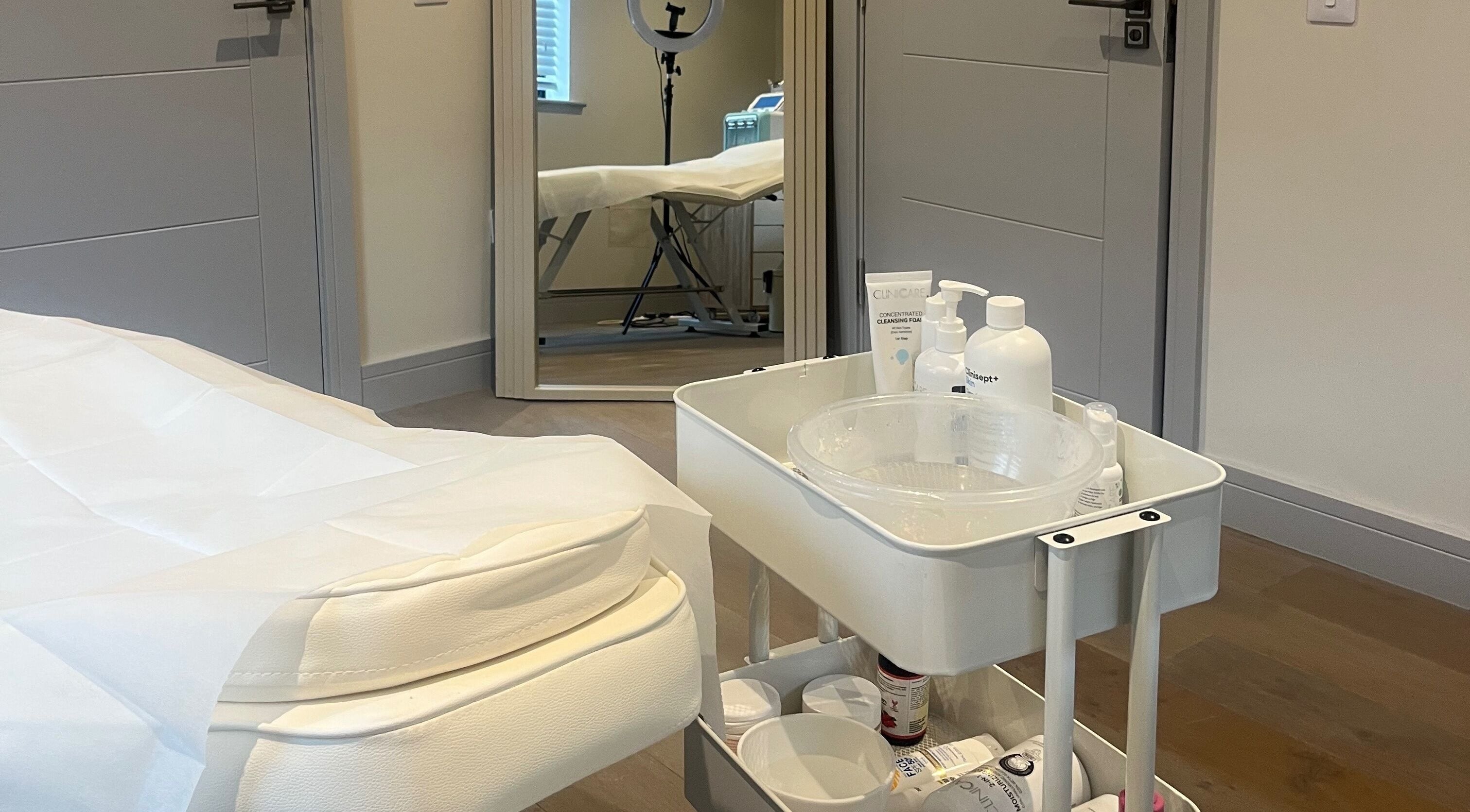 Relaxing treatment room at Skin Space in Stevenage, England, GB with a clean bed and skincare products.