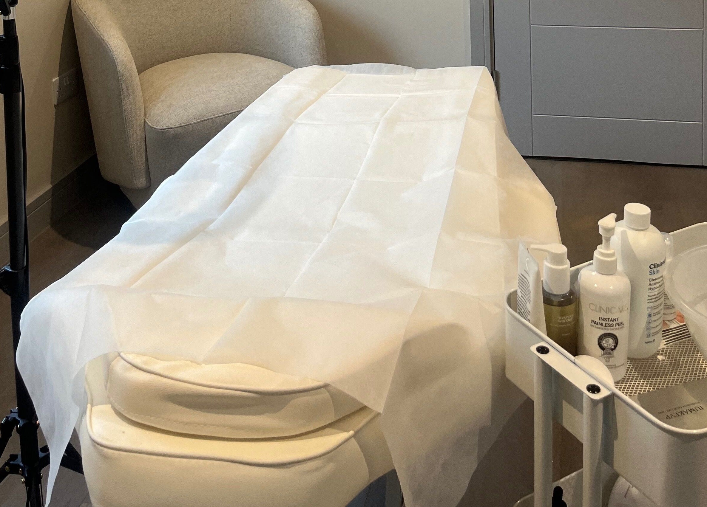 Relaxing treatment room at Skin Space, Stevenage, England. Features comfortable chair and skincare products.