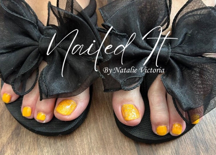 Yellow pedicure with black bows at Nailed It by Natalie Victoria, Doncaster, England, GB.