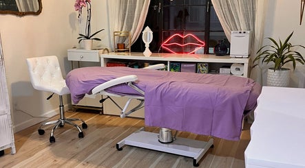 Relaxing therapy room at Makeup and Lashlift by Viktoriia Komarova, Del Mar, California, US featuring a purple massage bed.