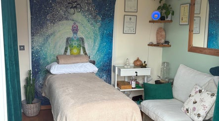 Tranquil therapy room at Bee Elevated Holistic Health, Holbury, England. Cozy bed and calming decor.