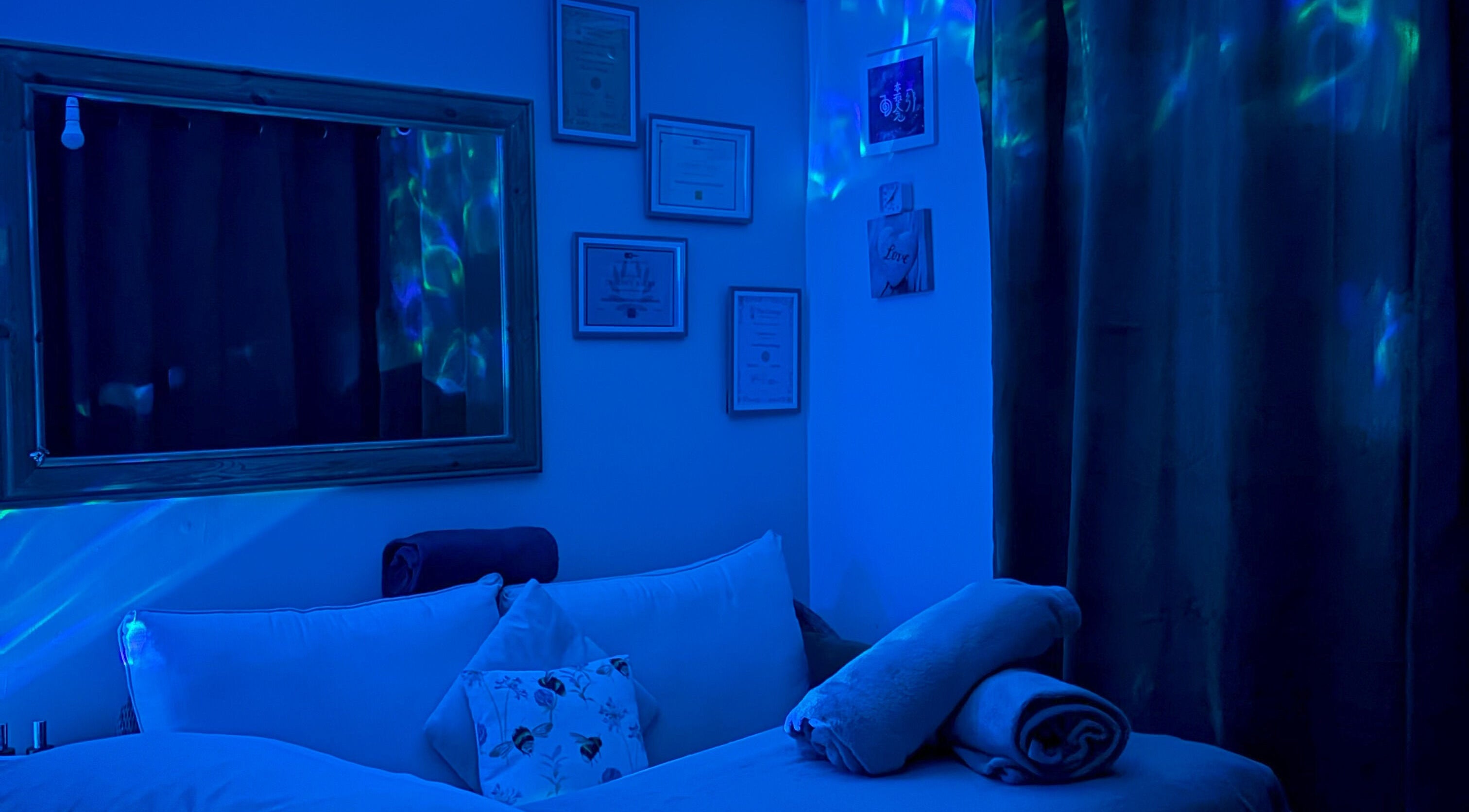 Tranquil therapy room at Bee Elevated Holistic Health in Holbury, England, GB with soothing blue lighting.