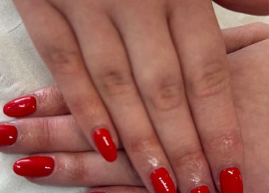 Bright red nails manicure at LJM Beauty in St Helens, England, GB.