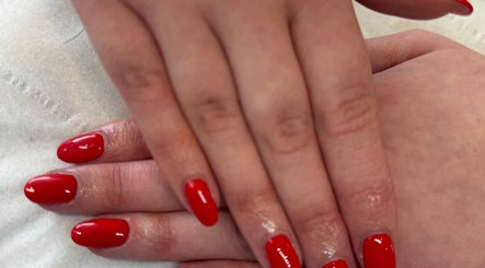 Bright red nails manicure at LJM Beauty in St Helens, England, GB.