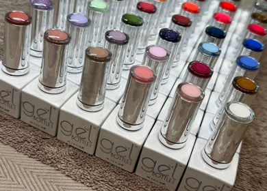 Array of colorful nail gel bottles at LJM Beauty, St Helens, England, GB, showcasing vibrant polish selection.