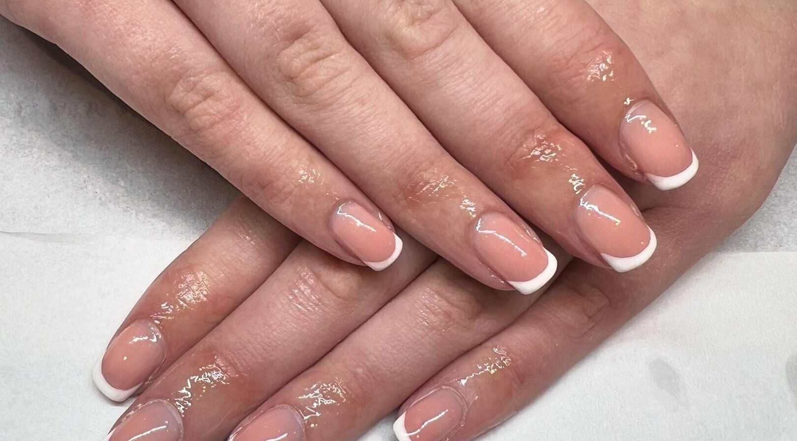 Elegant French manicure at LJM Beauty in St Helens, England, GB showcases perfectly polished nails.
