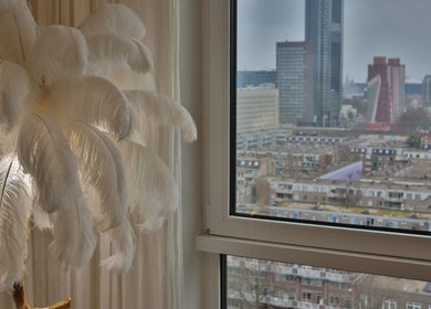 Elegant wit gevederde lamp bij Safferonails met uitzicht op Den Haag, Zuid-Holland, NL skyline.