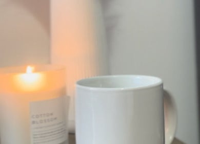 Lit candle and mug at Remi Room, Fareham, England, GB create a cozy and calming ambiance.