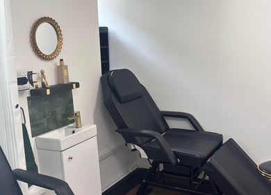 Luxe treatment room at Lumière by Brooke-Leigh, Chipping Sodbury, England, GB. Stylish black chair and chic decor.