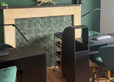 Elegant nail station at Lumière by Brooke-Leigh in Chipping Sodbury, England, GB, with green chairs and gold accents.