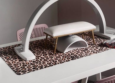Stylish nail station at Beautybycodz in Methil, Scotland, GB with leopard print mat and nail color samples.