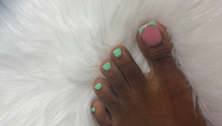 Stylish mint green pedicure from The Nail Candy at Cave Hill, Saint Lucy, BB on plush white fur.