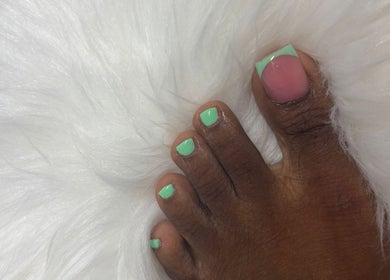 Stylish mint green pedicure from The Nail Candy at Cave Hill, Saint Lucy, BB on plush white fur.