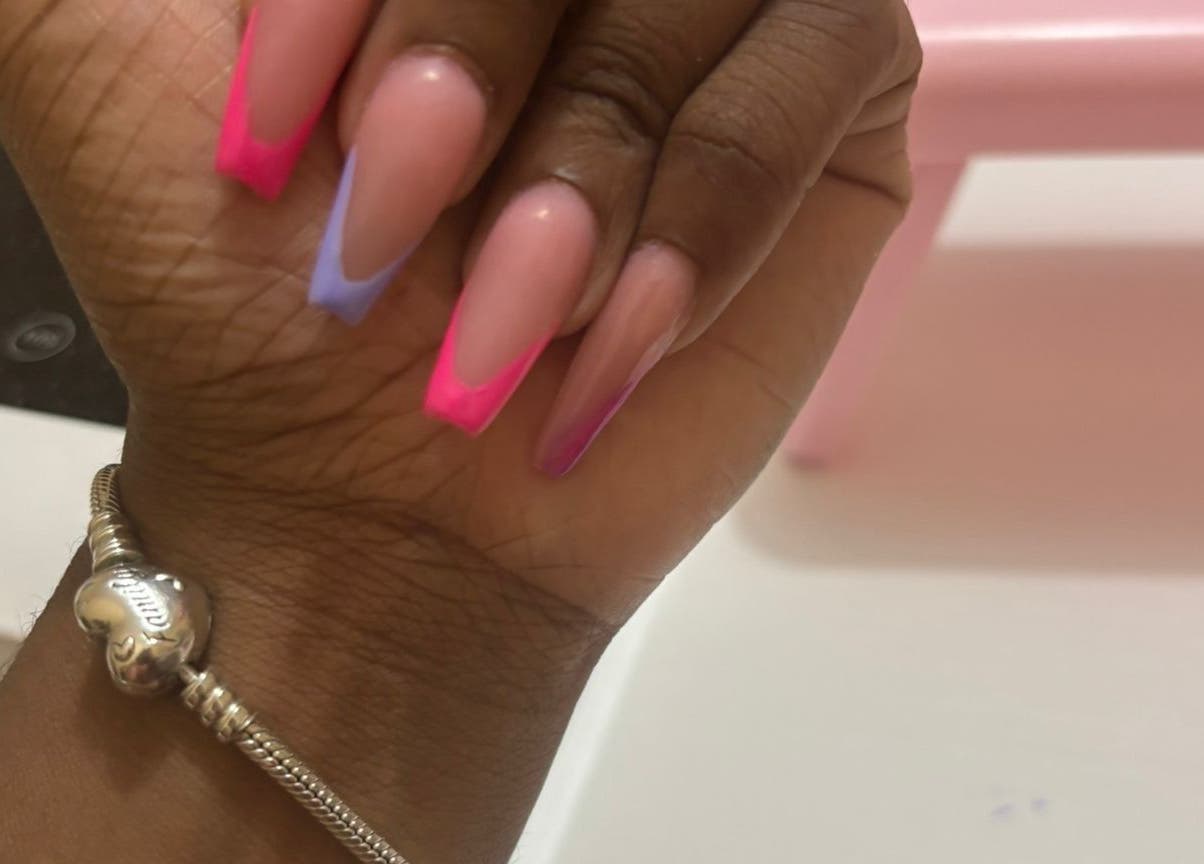 Bright nails at The Nail Candy, Cave Hill, Saint Lucy, BB showcasing colorful French tips.