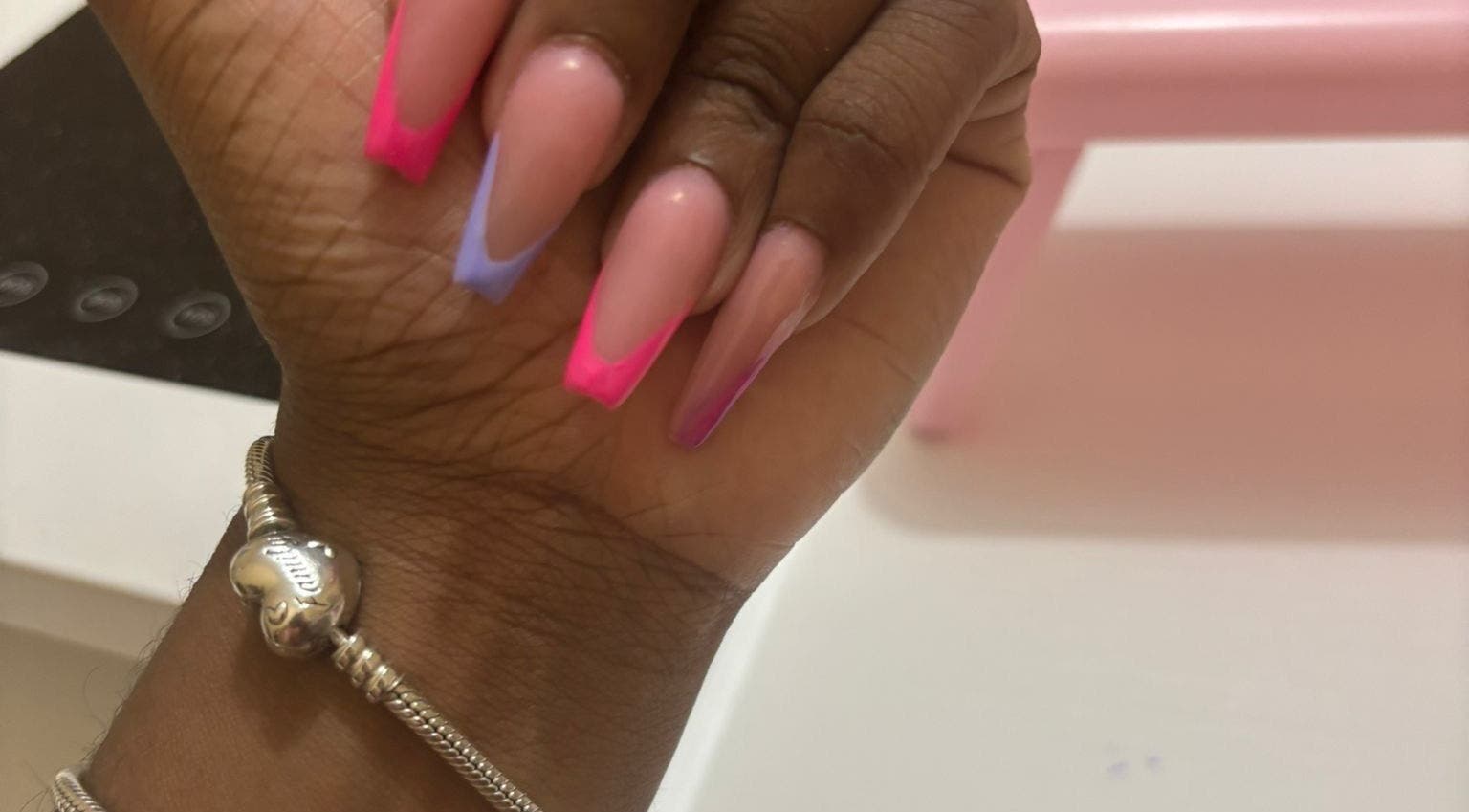 Bright nails at The Nail Candy, Cave Hill, Saint Lucy, BB showcasing colorful French tips.