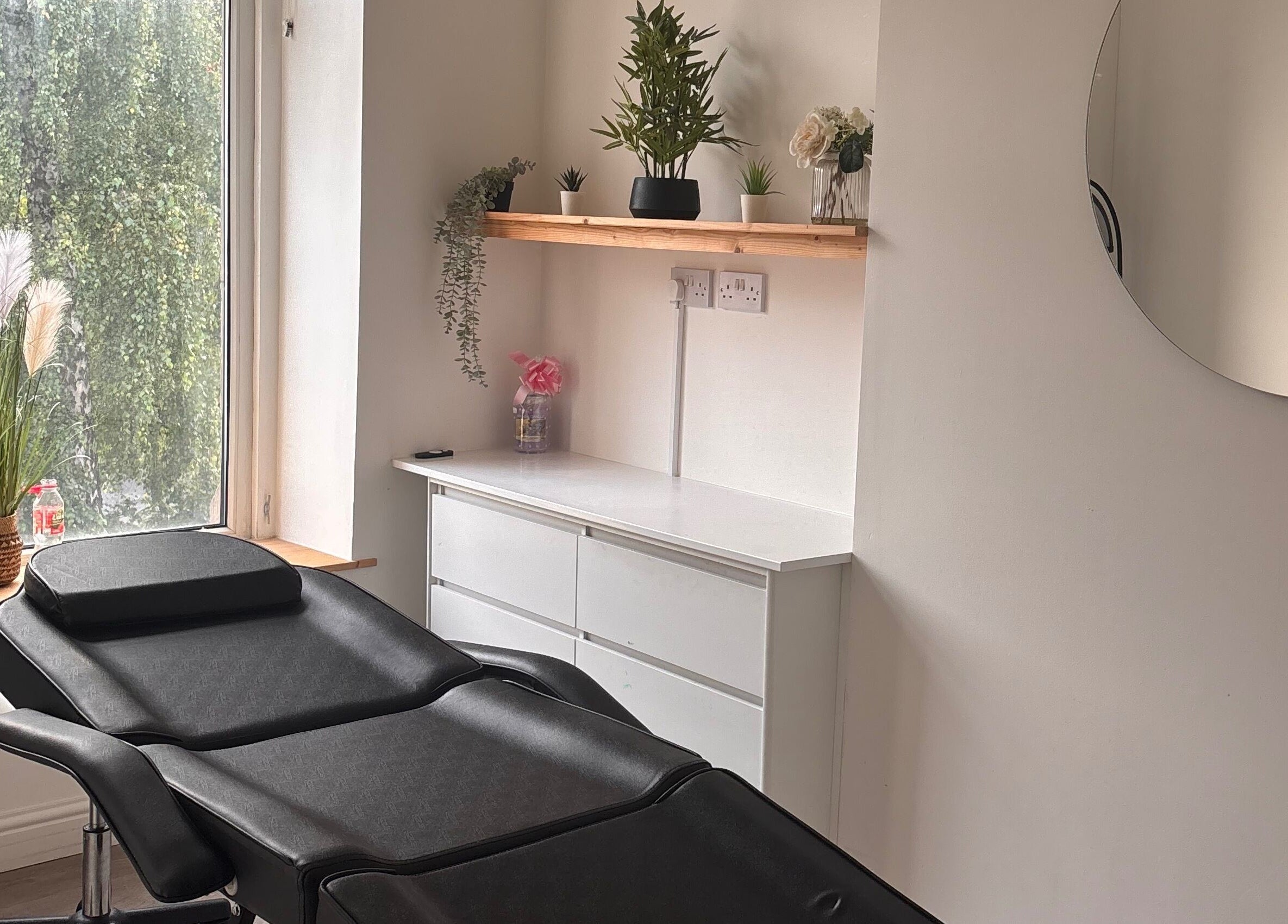 Relaxing beauty therapy room at ByEllebeauty, Darwen, England, GB with minimalist decor and greenery.