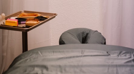 Massage table and tool tray at Scratched in Modesto, California, US, offering wellness treatments.