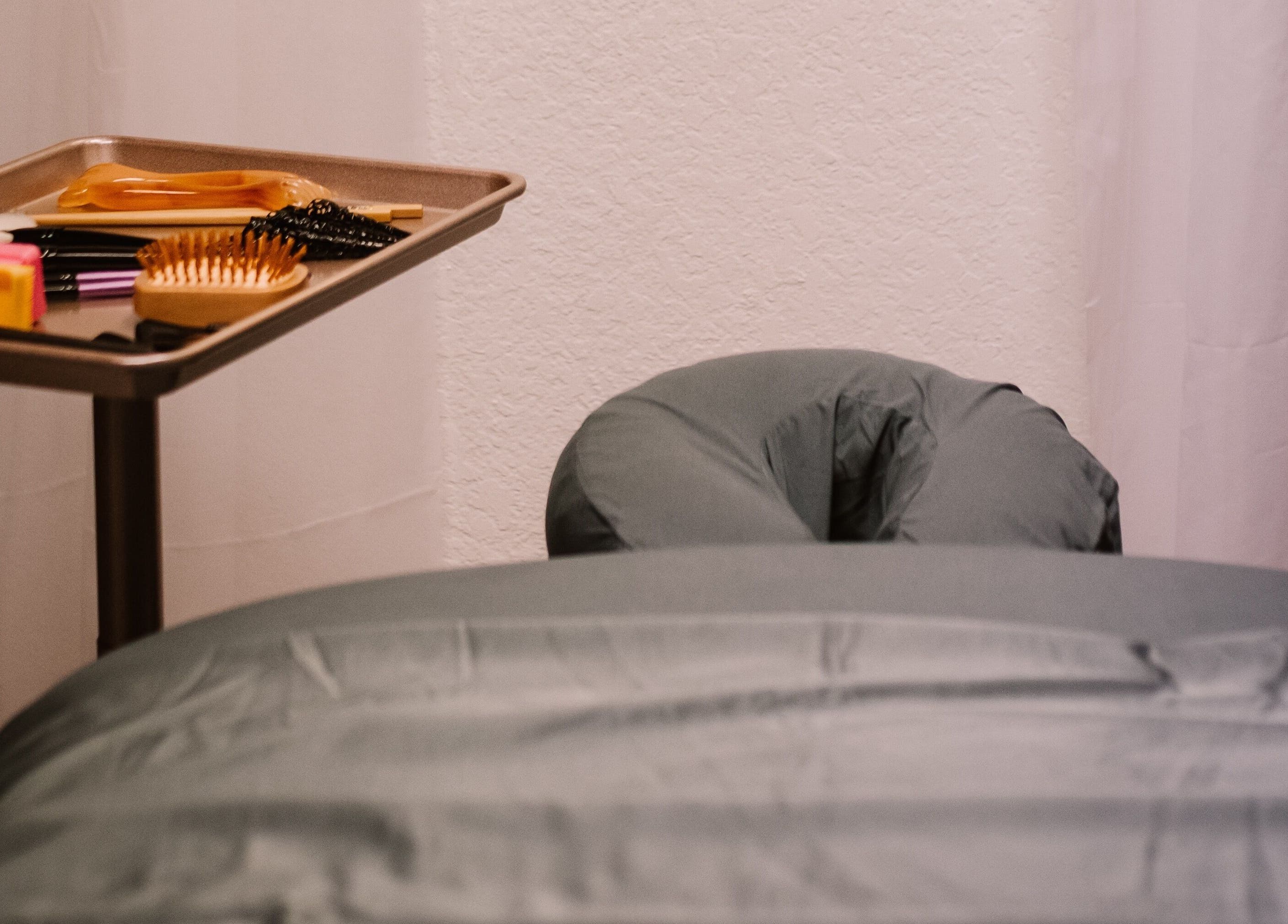 Massage setup at Scratched in Modesto, California, US with tools and a treatment bed.