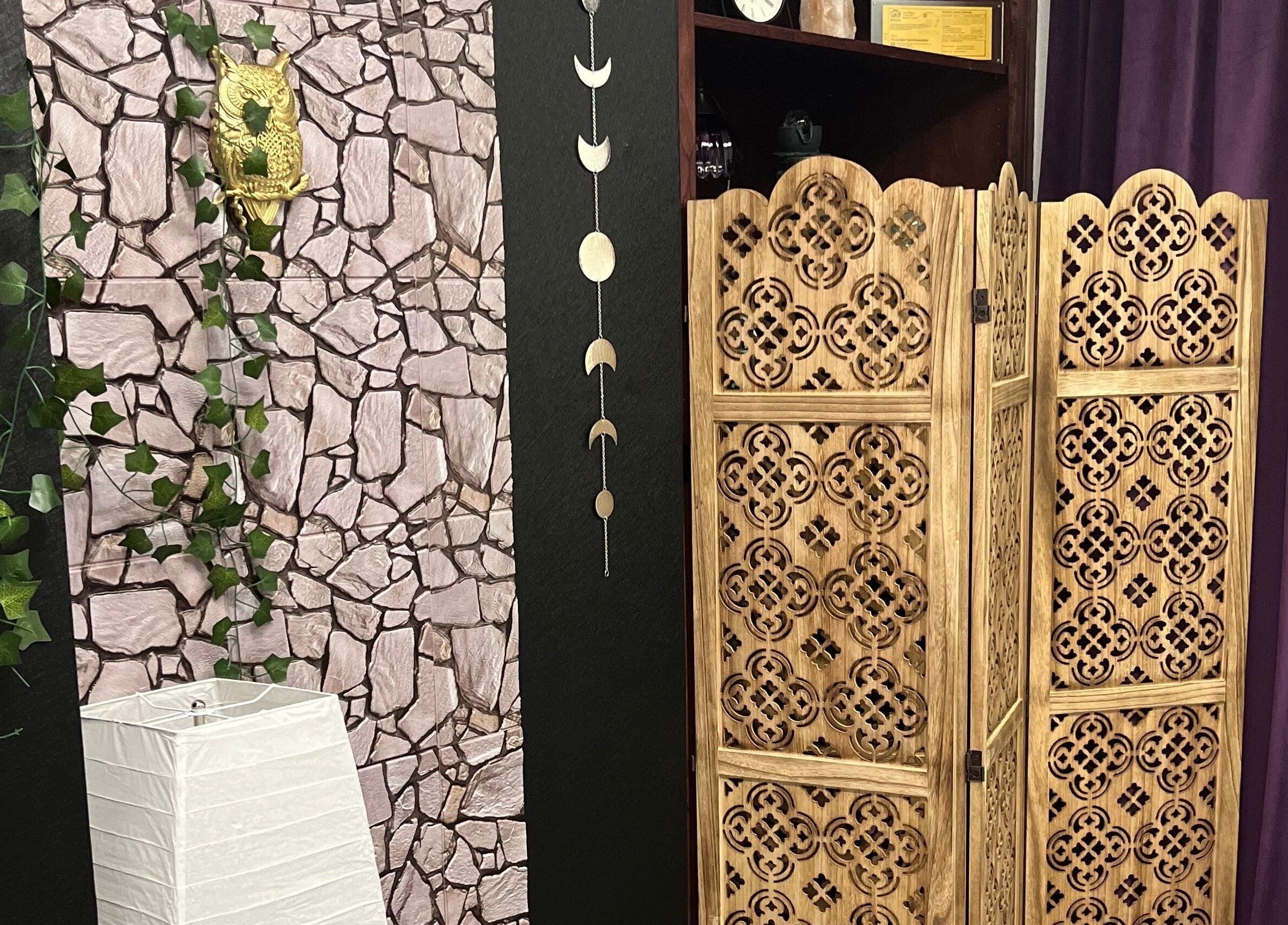 Elegant wooden screen with stone backdrop at Scratched, Modesto, California, US, creating a serene ambiance.