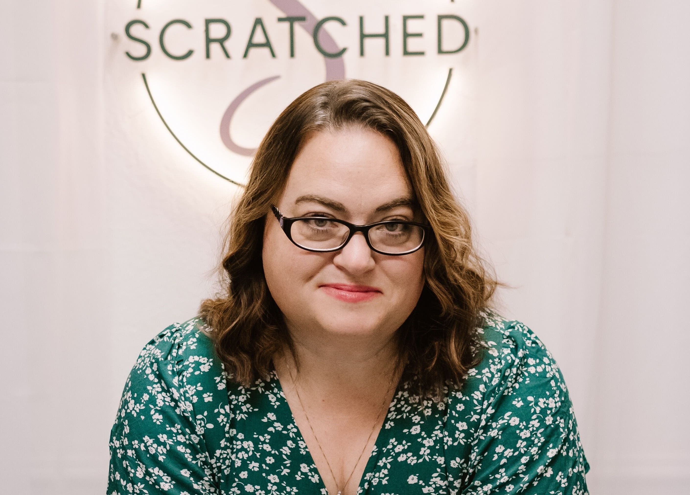 Person smiling at Scratched venue in Modesto, California, US with elegant decor.