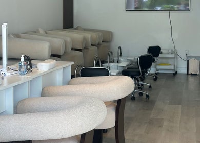 Stylish interior of Elavine Nail Studio, Toronto, Ontario, CA, featuring modern nail stations and plush seating.
