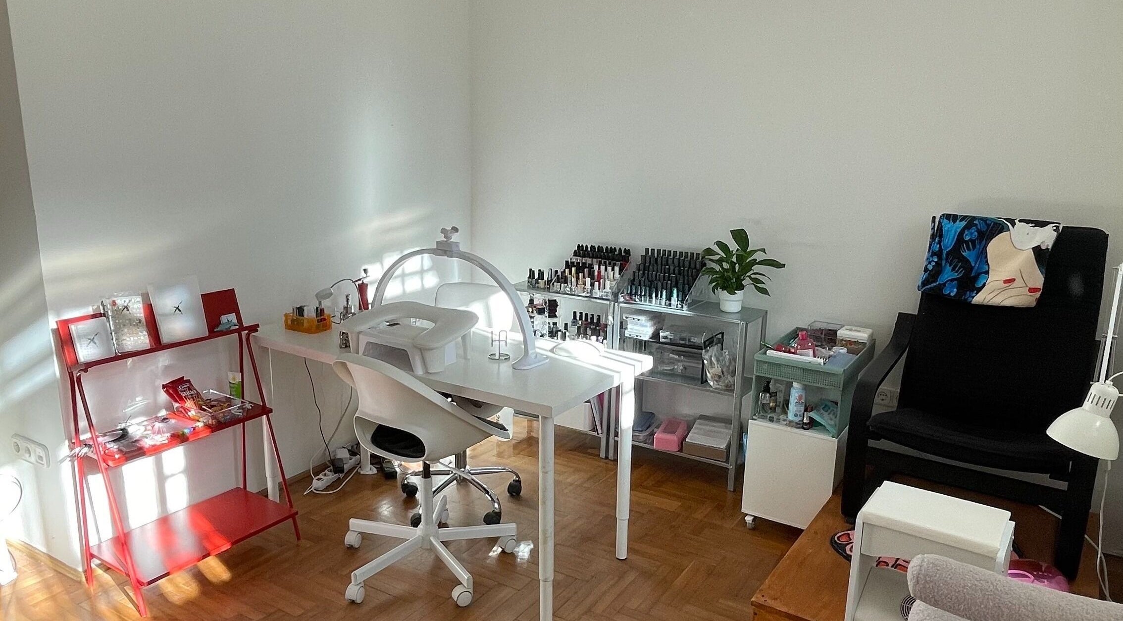 Modern nail studio at Nails x Lolita in Budapest, Magyar, HU with stylish decor and organized nail polishes.