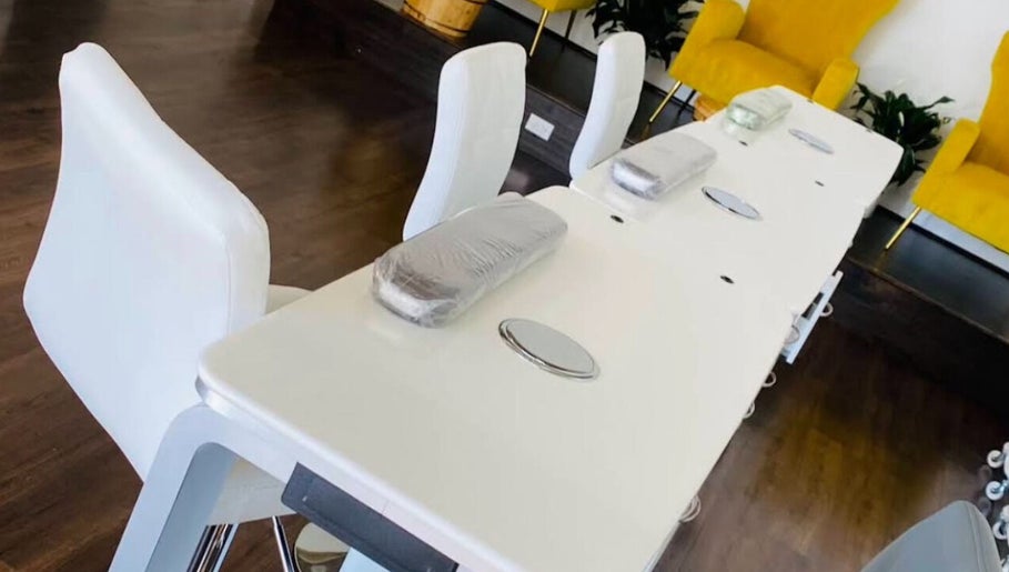 Modern nail stations at Nailington Nail Boutique, Los Angeles, California, US, with sleek white seating.