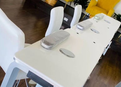 Modern nail stations at Nailington Nail Boutique, Los Angeles, California, US, with sleek white seating.