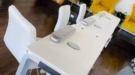 Modern nail stations at Nailington Nail Boutique, Los Angeles, California, US, with sleek white seating.