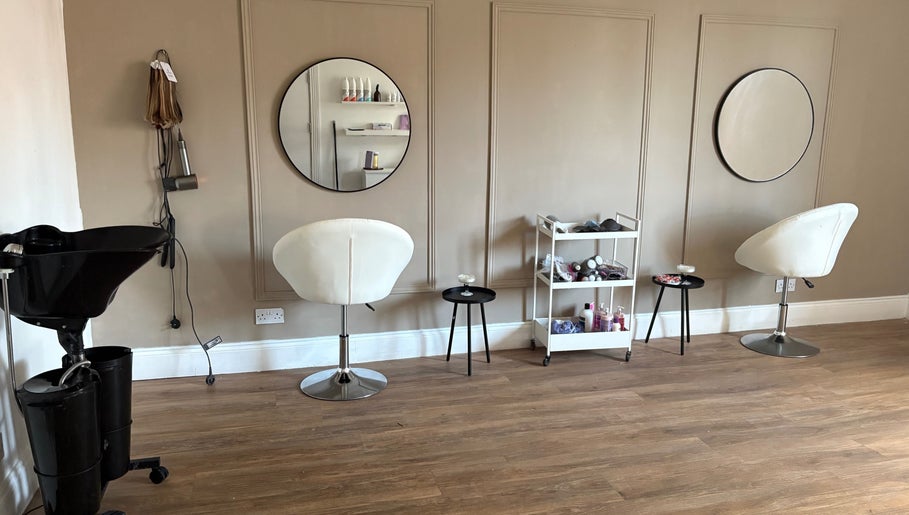 Modern salon interior at Locksoflove, Whitley Bay, England, GB with stylish chairs and mirrors.