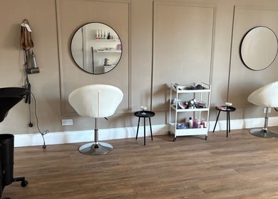 Modern salon interior at Locksoflove, Whitley Bay, England, GB with stylish chairs and mirrors.