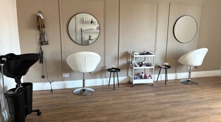 Modern salon interior at Locksoflove, Whitley Bay, England, GB with stylish chairs and mirrors.