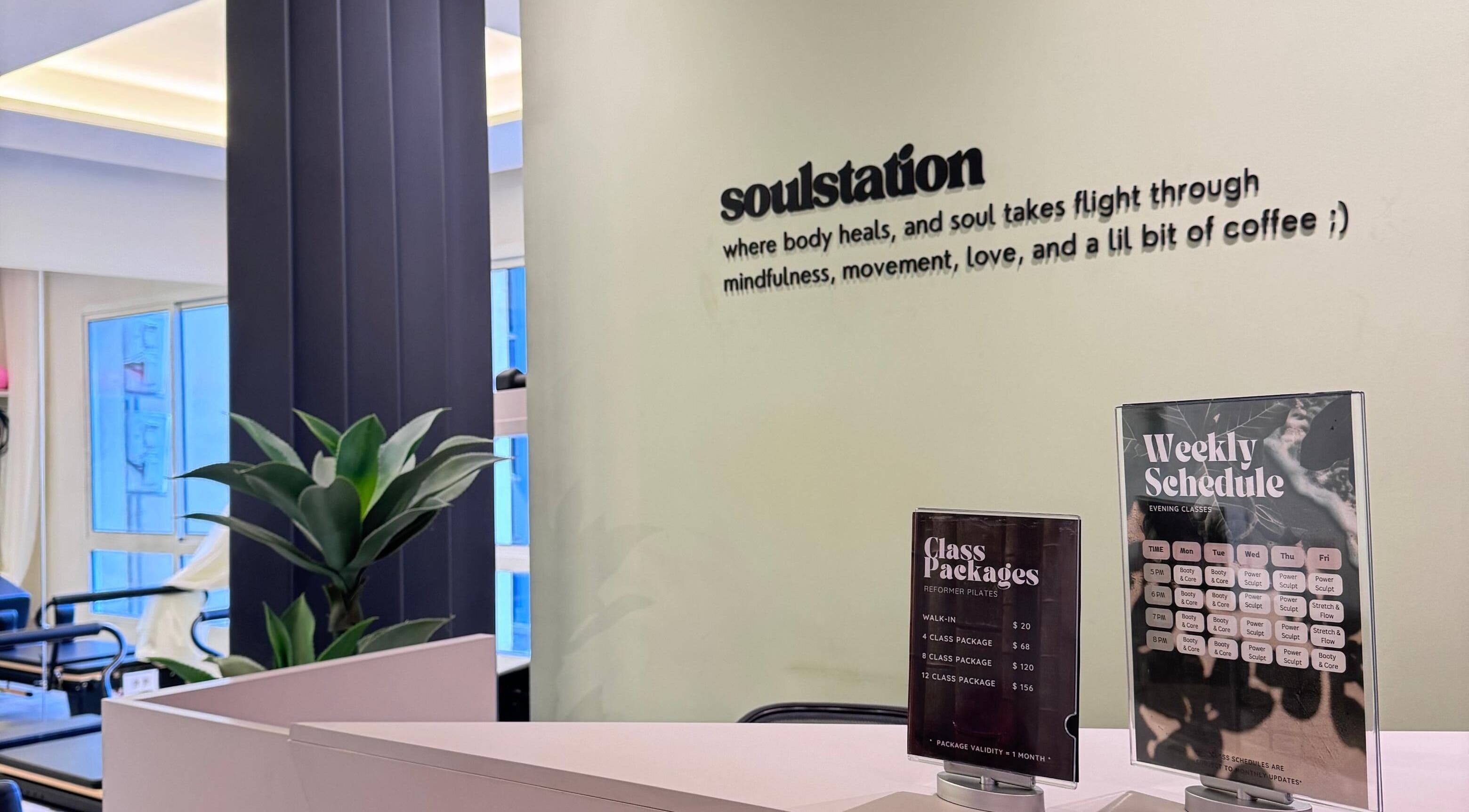 Reception area of SoulStation Pilates, Zalqa, Mount Lebanon Governorate, LB with class schedules displayed.