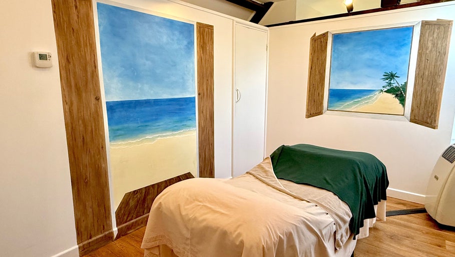 Relaxing spa room at All Elements in Wellington, England, GB, featuring beach-themed murals and serene decor.