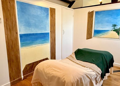 Relaxing spa room at All Elements in Wellington, England, GB, featuring beach-themed murals and serene decor.