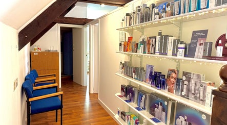 Sleek beauty product display at All Elements in Wellington, England, GB enhances the cozy waiting area.