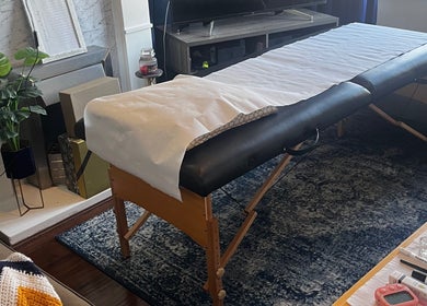 Massage table at Flutterbrows, Rumney, Wales, GB. Cozy, tranquil setting for beauty and wellness treatments.
