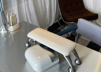 Sleek nail station at Heaps Good Nails, London, England, GB, showcasing modern manicure equipment and seating.