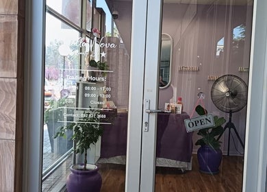 Entrance of Stella Nova Beauty Bar in Bloemfontein, Free State, ZA with open sign and elegant decor.