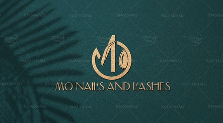 Elegant logo of MO Nails and Lashes, Auckland, Auckland, NZ, featuring a gold motif on a textured background.