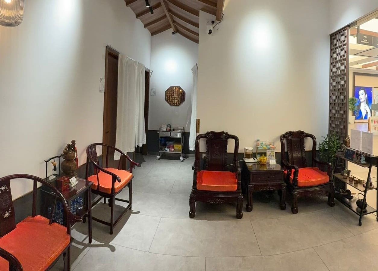 Welcoming interior of TCM Acupuncture Therapy Center in Dubai, AE, featuring elegant wooden chairs and soothing decor.
