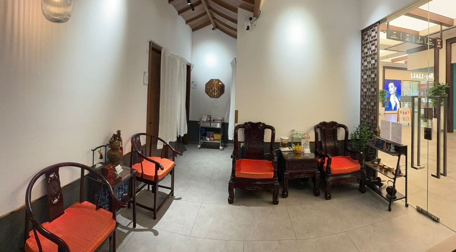 Welcoming interior of TCM Acupuncture Therapy Center in Dubai, AE, featuring elegant wooden chairs and soothing decor.