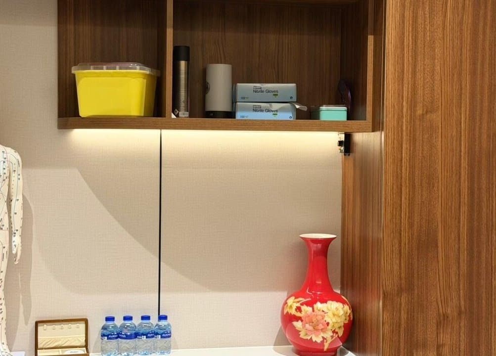 Interior of TCM Acupuncture Therapy Center in Dubai, AE featuring anatomical model and decorative vase.
