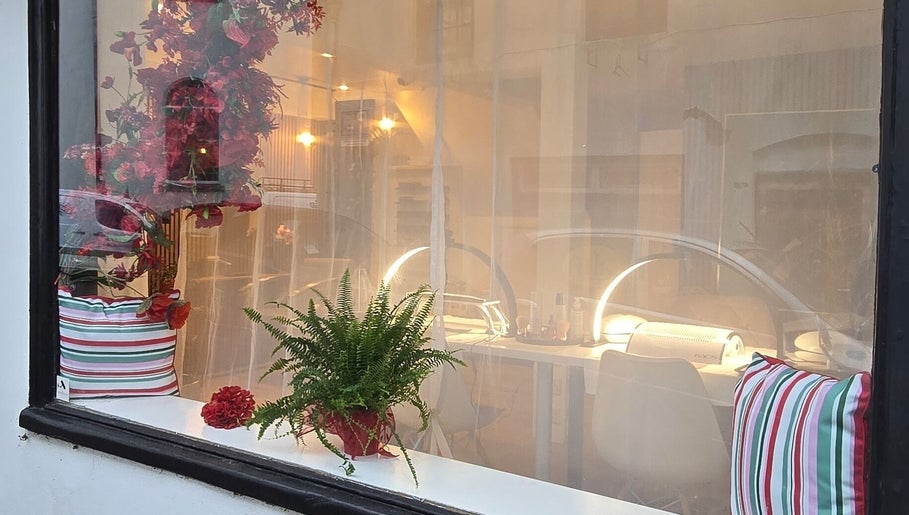 Inviting window view of Little Red, a beauty venue in London, England, GB with vibrant decor.