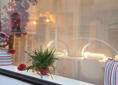 Inviting window view of Little Red, a beauty venue in London, England, GB with vibrant decor.