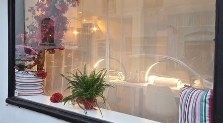 Inviting window view of Little Red, a beauty venue in London, England, GB with vibrant decor.
